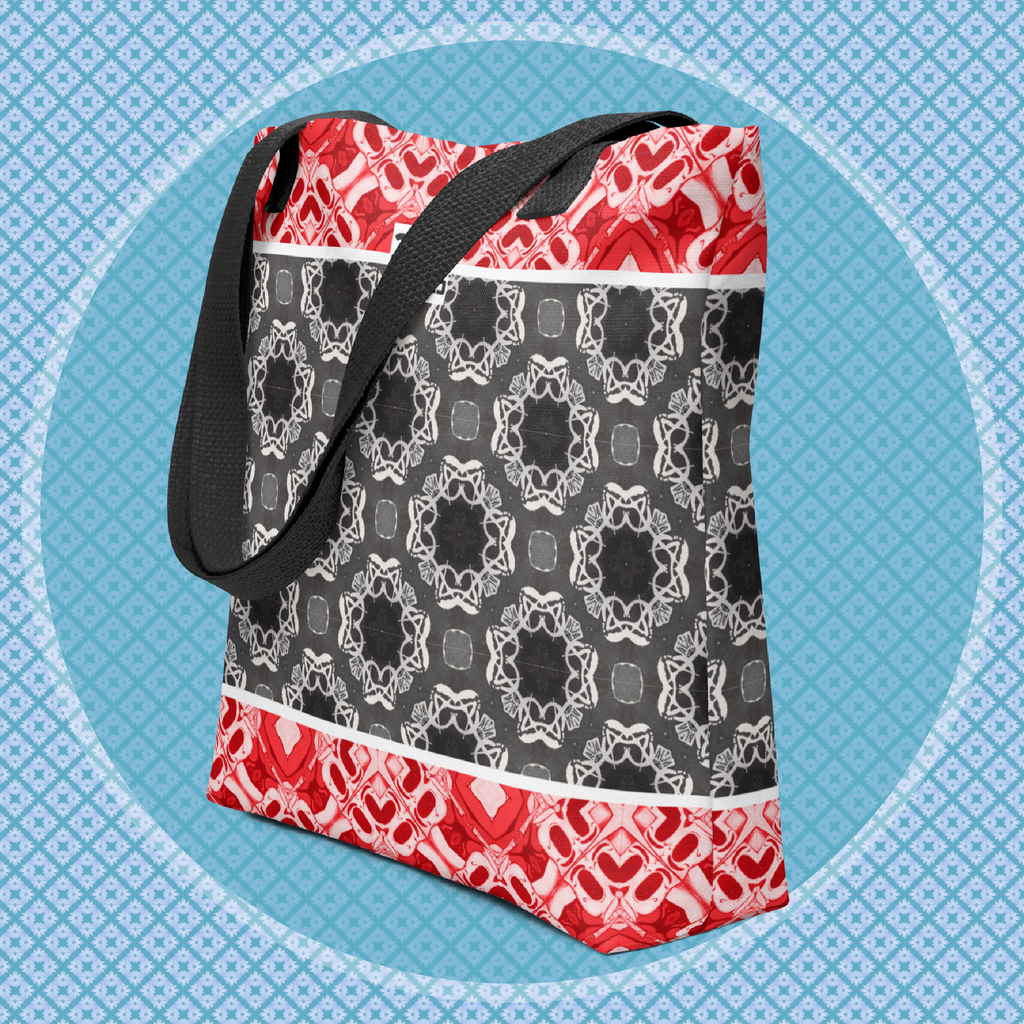 Tote bag with red, black, and white geometric pattern on a blue background