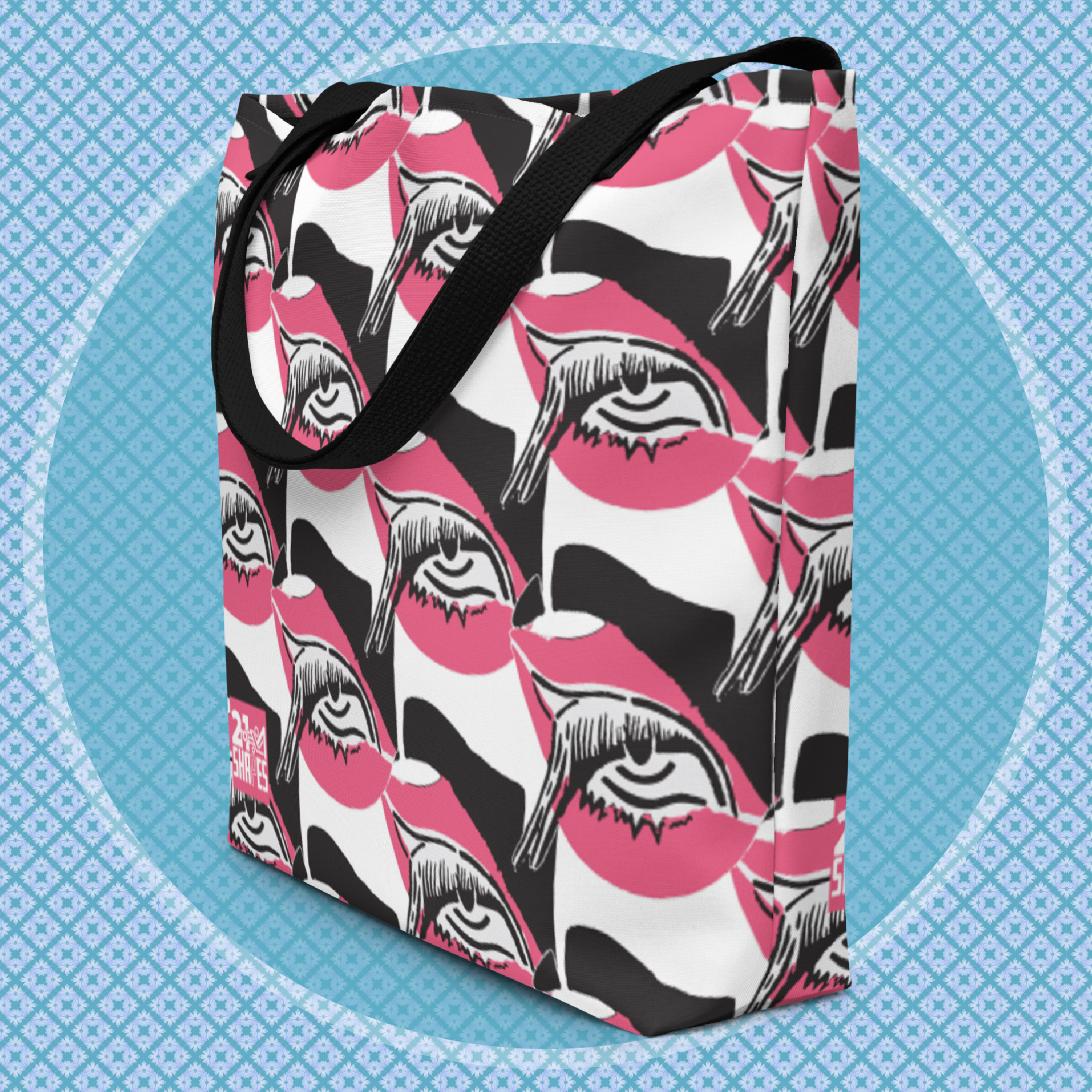 Tote bag with black, white and pink design of a repeating eye on a blue patterned background